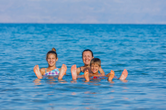 family floating in dead sea israel
