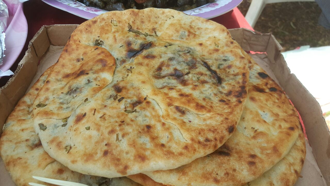 Fresh stuffed pita, straight out of the oven: one of the most beloved dishes on our Druze culinary experience.